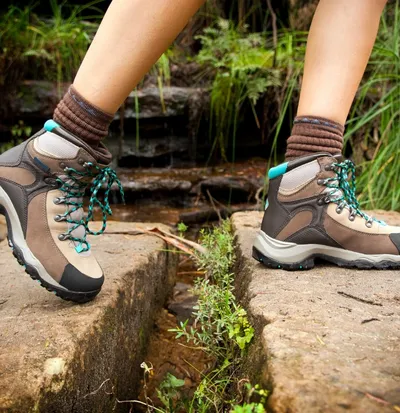 Hiking in rugged terrain with sturdy footwear and nature surrounding at mid-day